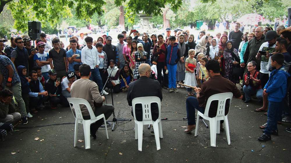 Amir in a trio sharing traditional Persian music at Harmony Day celebrations.