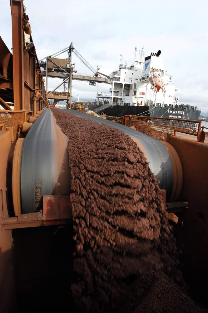 Iron ore is transported via a series of conveyor belts.