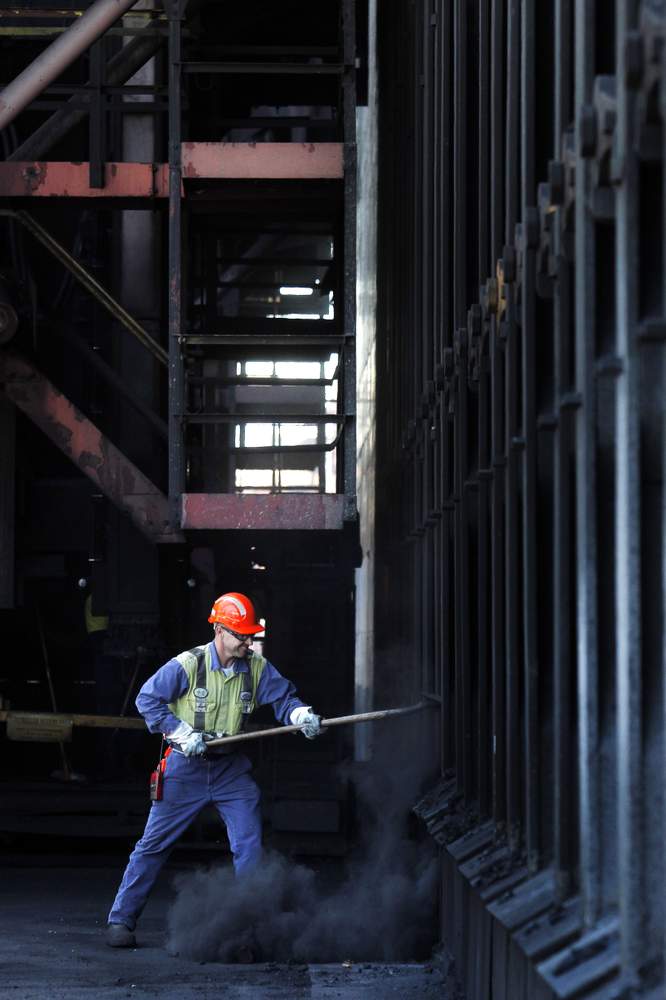 Steven Giles cleaning out one of the sills at the No7 coke ovens batter, a long line of thin, vertical ovens where coal is heated so it turns to coke.