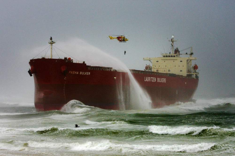 Glen Ramplin dangles above the Pasha Bulker&#39;s deck. Picture: Darren Pateman